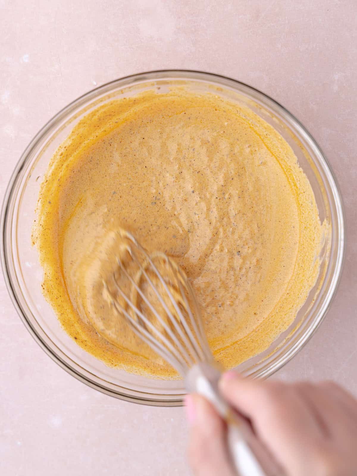 Smokey and creamy Greek yogurt dressing is whisked together in a small glass bowl.