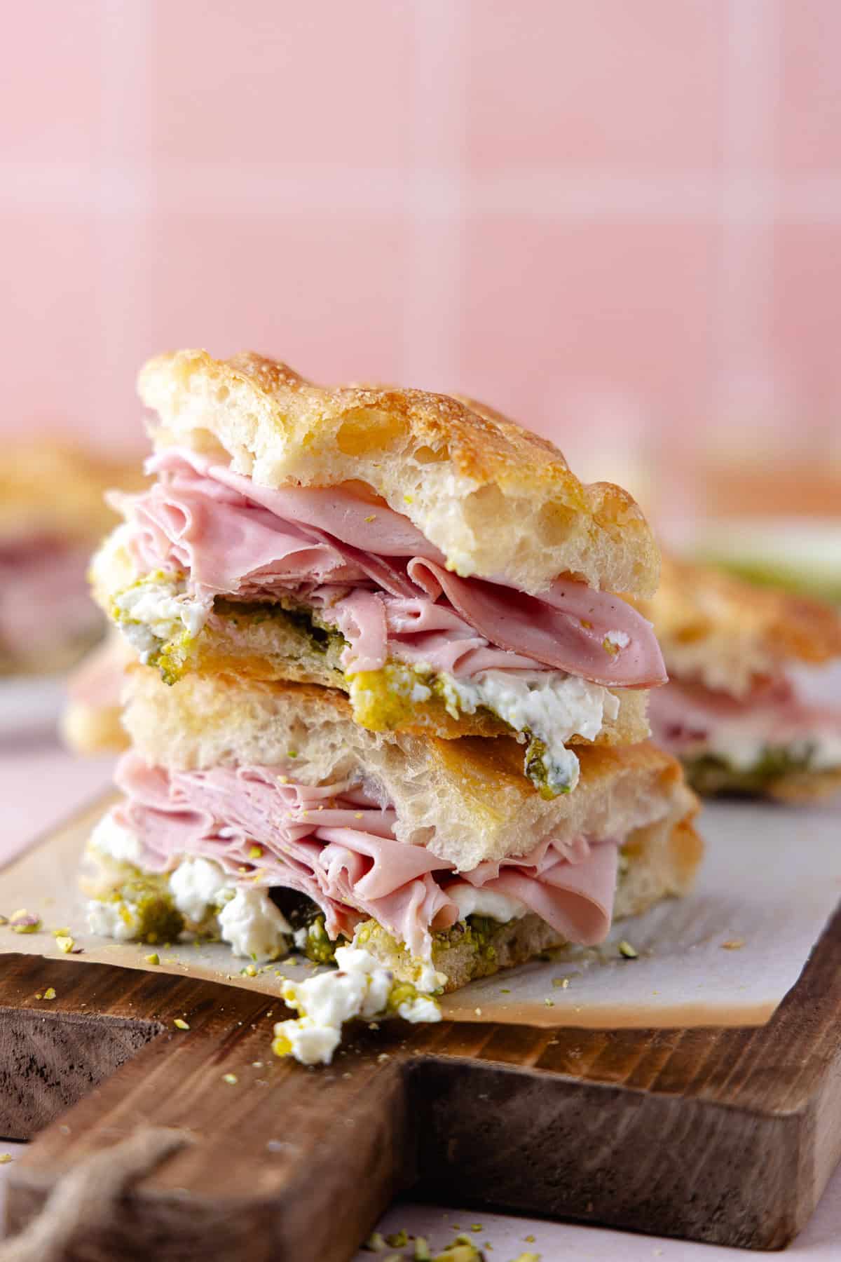 Pistachio mortadella sandwich with pistachio spread and stracciatella cheese on homemade schiacciata bread.