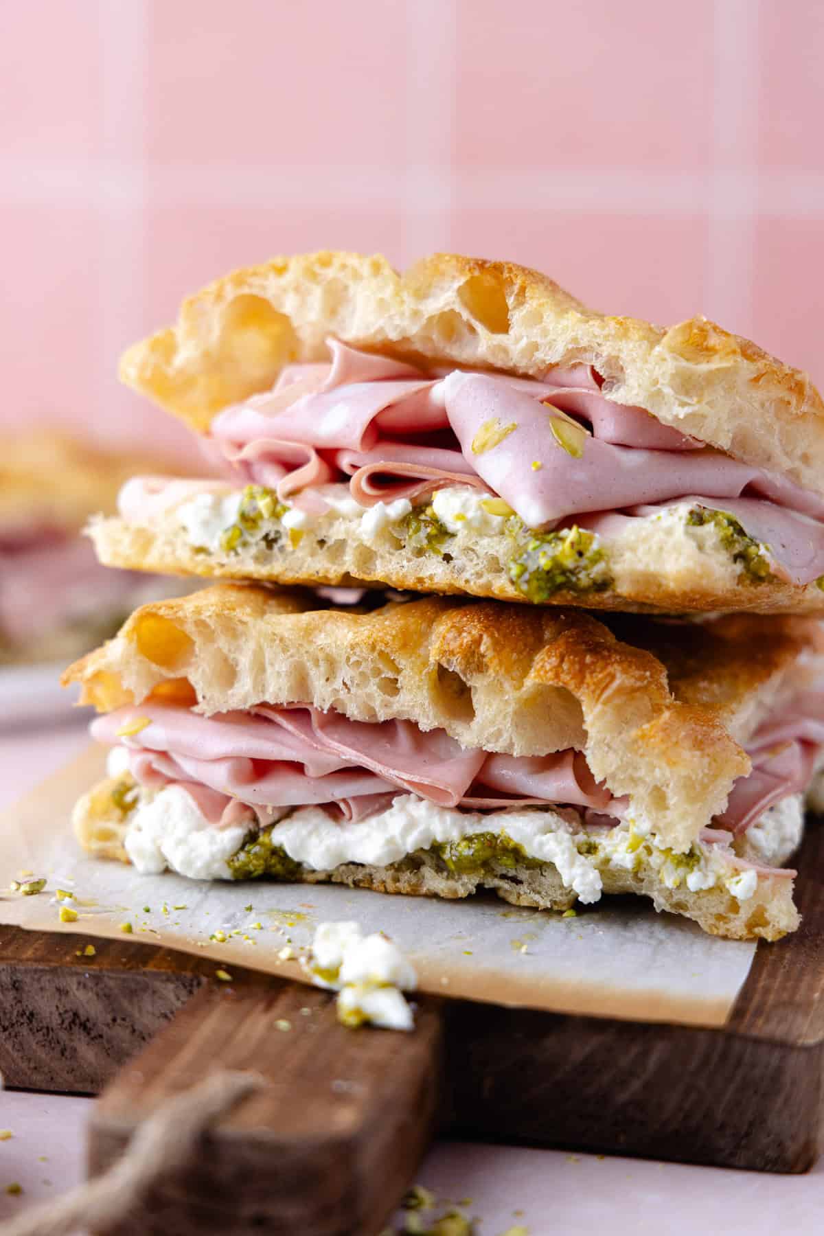 Pistachio mortadella sandwich with pistachio spread and stracciatella cheese on homemade schiacciata bread.