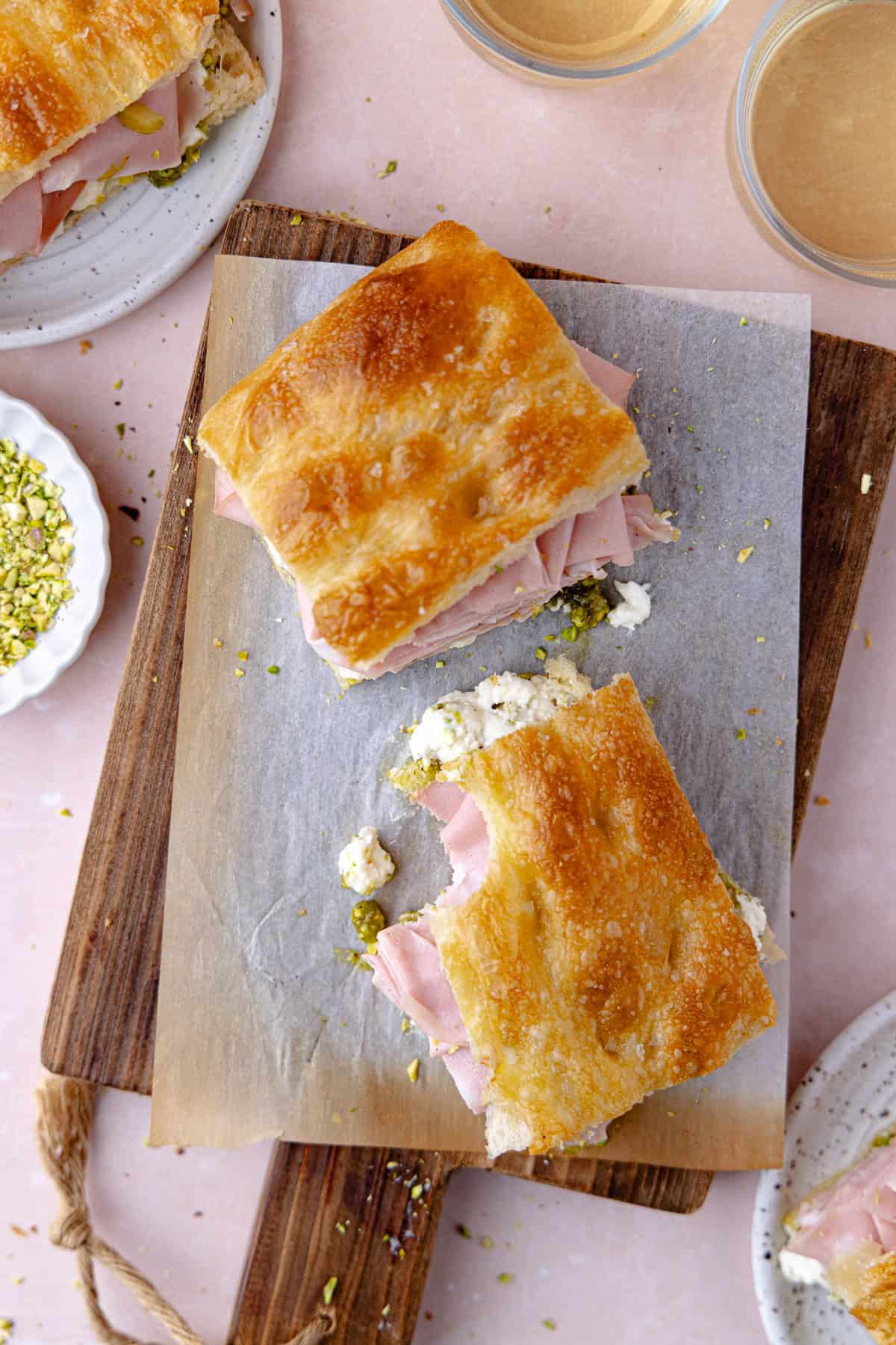Pistachio mortadella sandwich with pistachio spread and stracciatella cheese on homemade schiacciata bread.