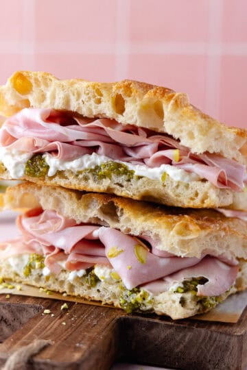 Pistachio mortadella sandwich with pistachio spread and stracciatella cheese on homemade schiacciata bread featured photo.