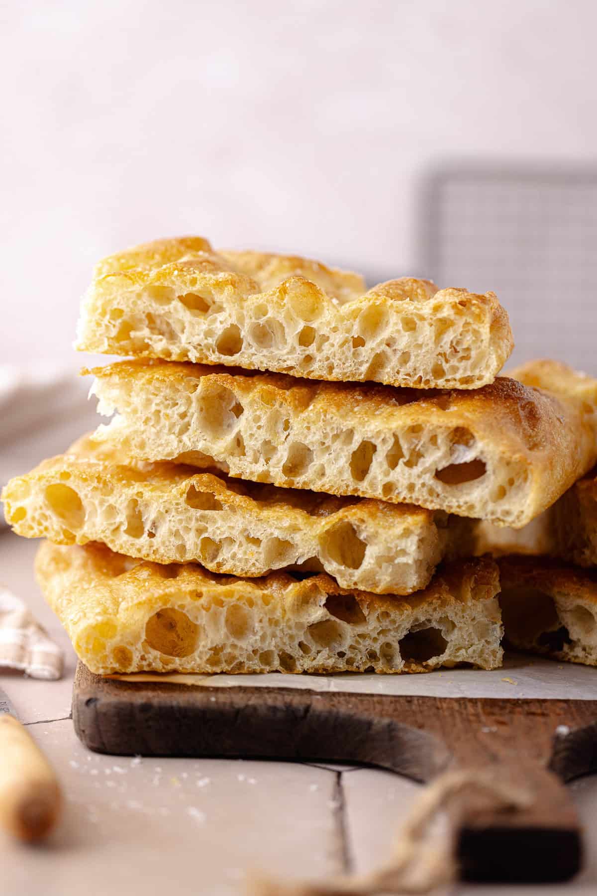 Schiacciata bread recipe sliced and sitting on a cutting board.
