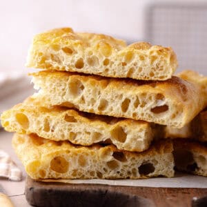 Schiacciata bread recipe sliced and sitting on a cutting board featured photo.