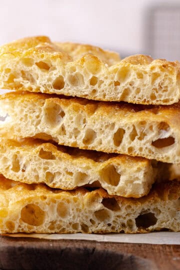 Schiacciata bread recipe sliced and sitting on a cutting board featured photo.