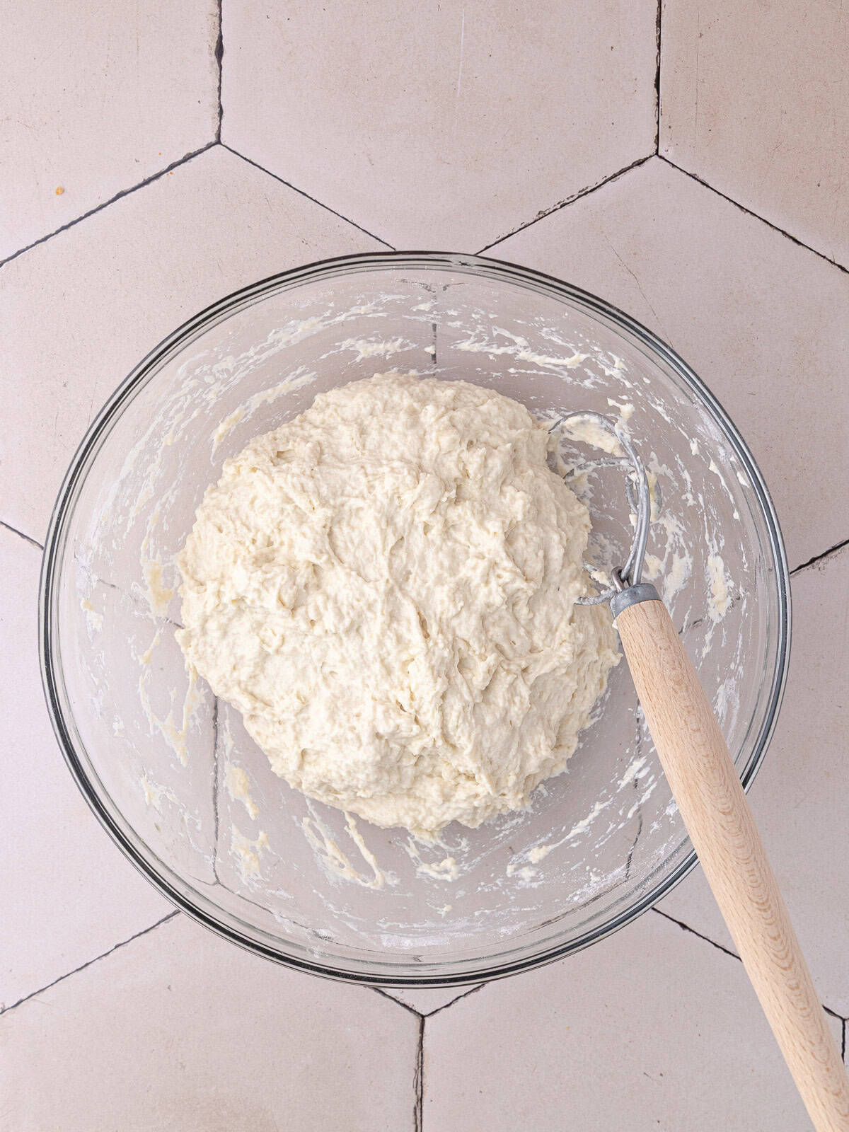 The schiacciata bread dough ingredients are mixed together to form a shaggy ball of dough.