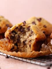 A small batch of chocolate chip banana muffins on a wire rack feature photo.