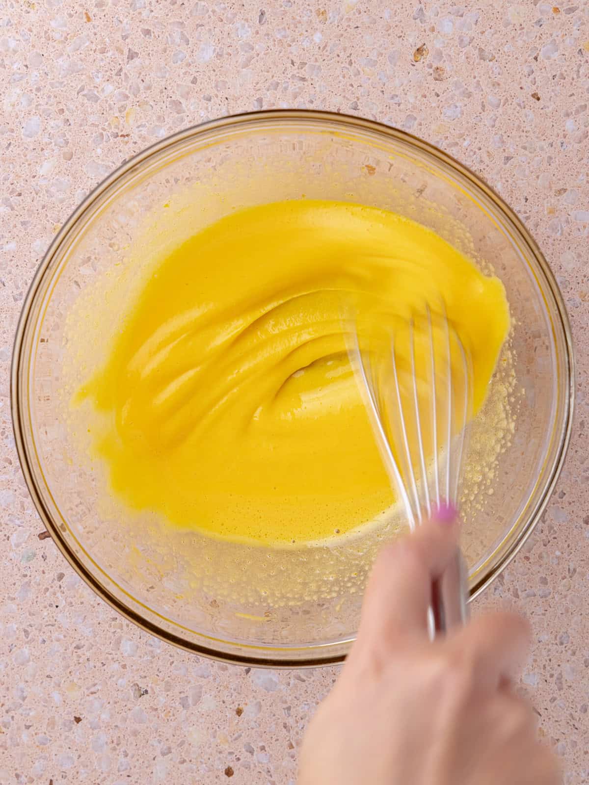 Yolks and sugar is whisk together in a small glass bowl until light and fluffy.
