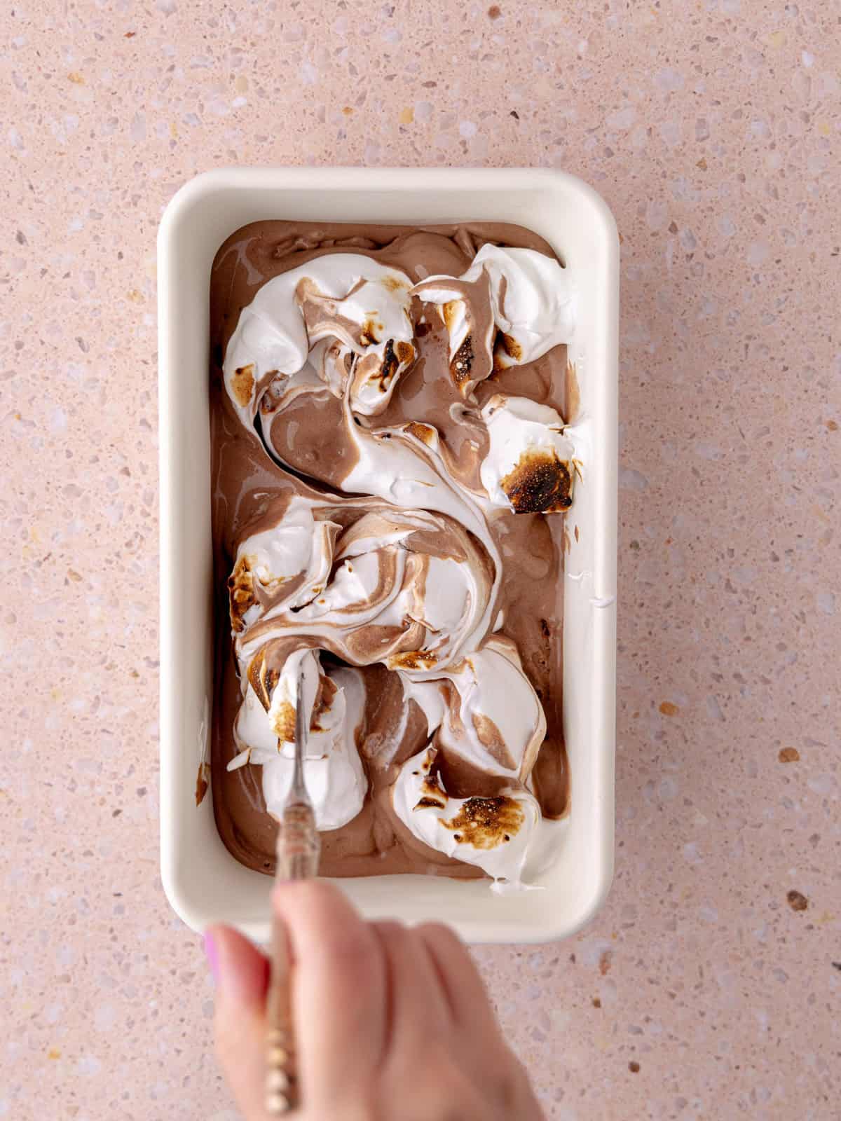 Torched marshmallow meringue is swirled together with the chocolate ice cream.