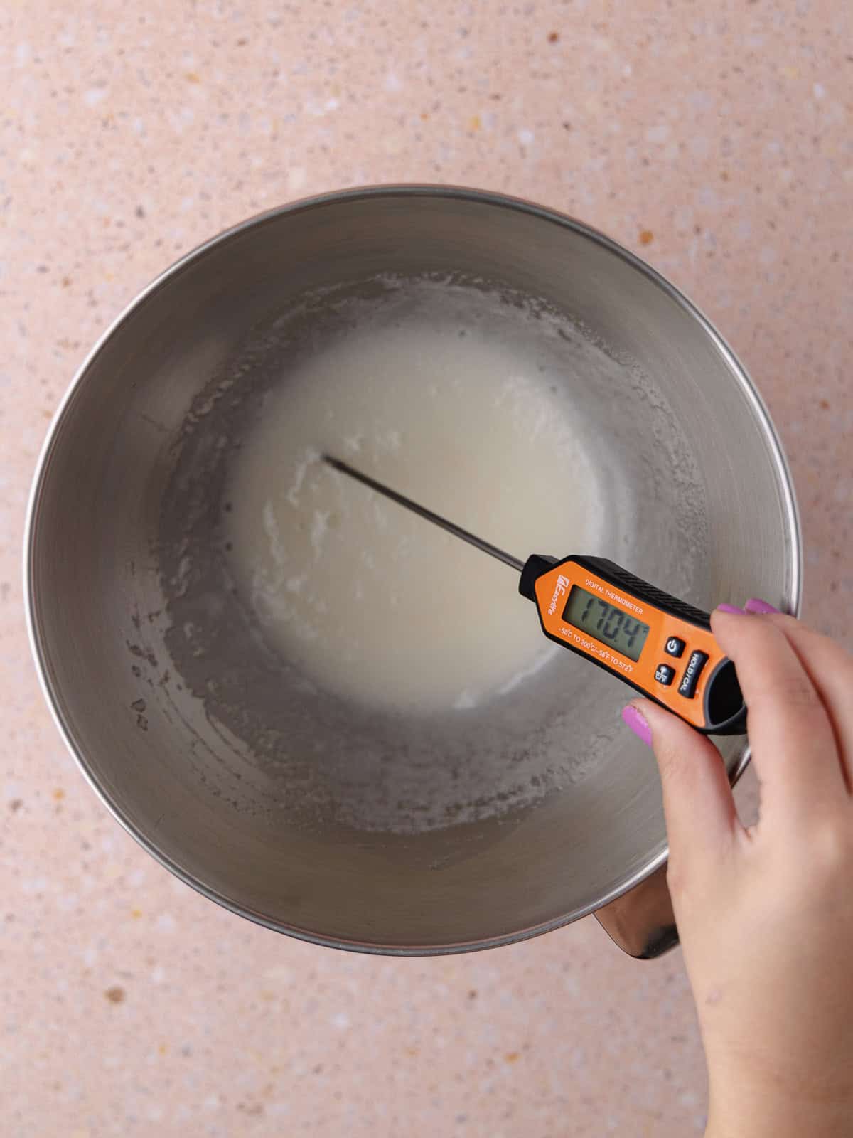 Egg whites and sugar is heated over a double boiled until it reaches 170 degrees fahrenheit.