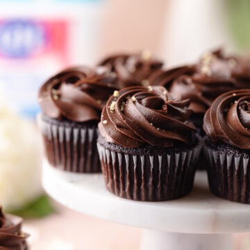 Chocolate hazelnut cupcakes filled with nutella hazelnut filling and frosted with a chocolate hazelnut buttercream feature photo.