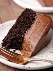 Triple dark chocolate mousse cake sliced on a dessert plate featured photo.
