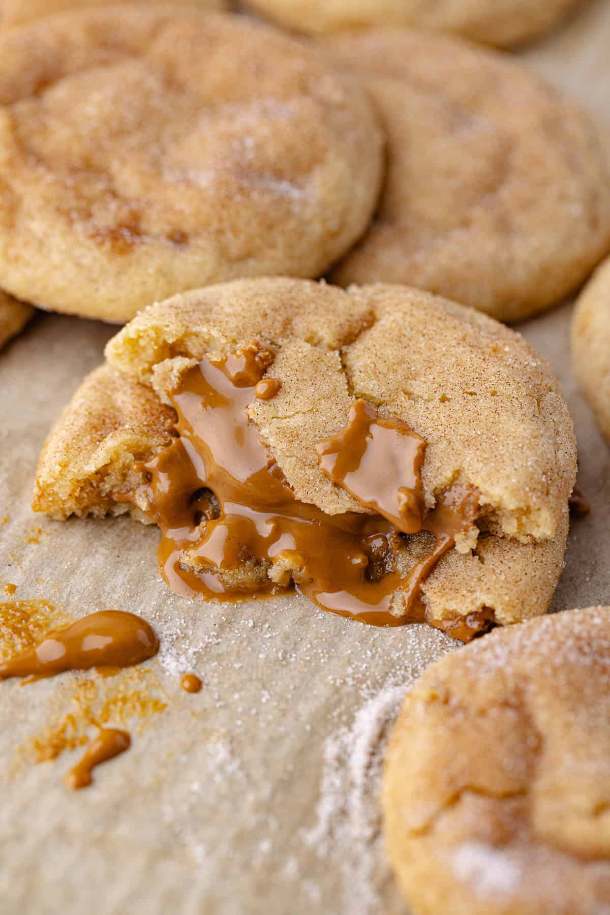 Gooey Biscoff stuffed snickerdoodle cookies sitting on a baking sheet.