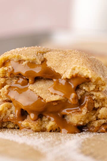Gooey Biscoff stuffed snickerdoodle cookies sitting on a baking sheet feature photo.