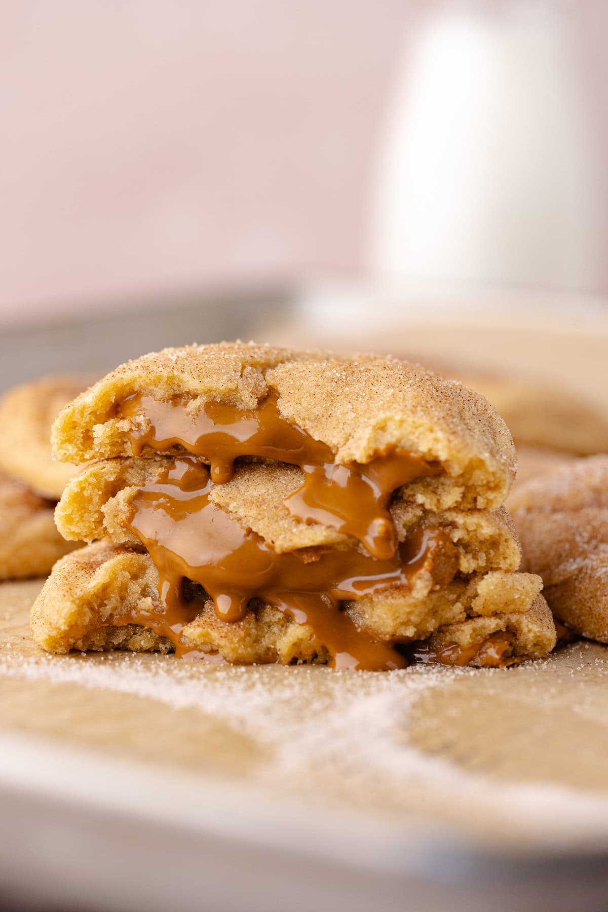 Gooey Biscoff stuffed snickerdoodle cookies sitting on a baking sheet.
