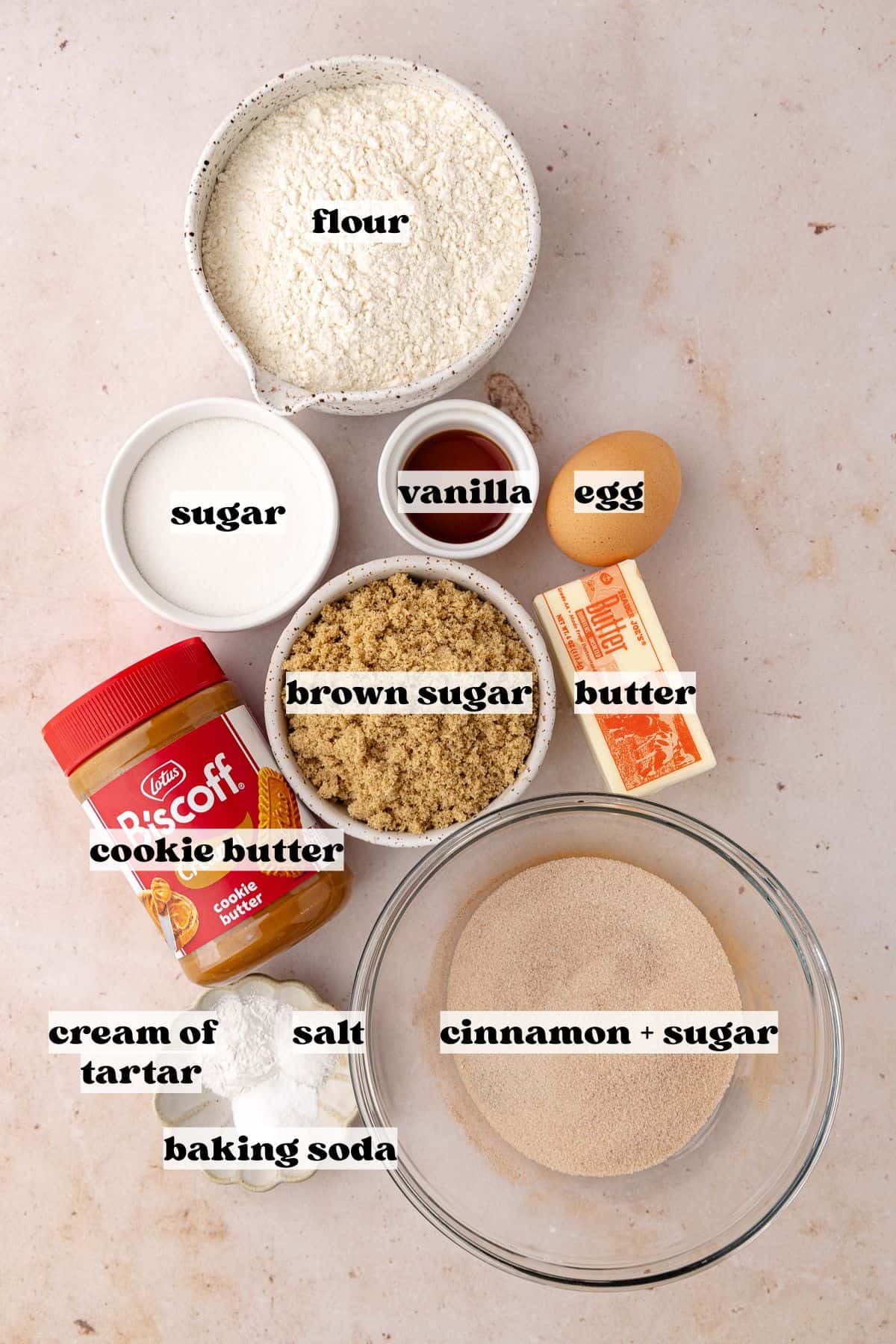 Biscoff stuffed snickerdoodle cookies ingredients which include, flour, baking soda, cream of tartar, salt, butter, white sugar, brown sugar, vanilla, egg, biscoff cookies butter and cinnamon sugar.