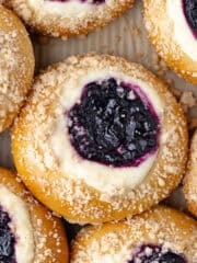 Blueberry cheesecake brioche buns, filled with a cheesecake filling, homemade wild blueberry jam, and then baked with a streusel topping feature photo.