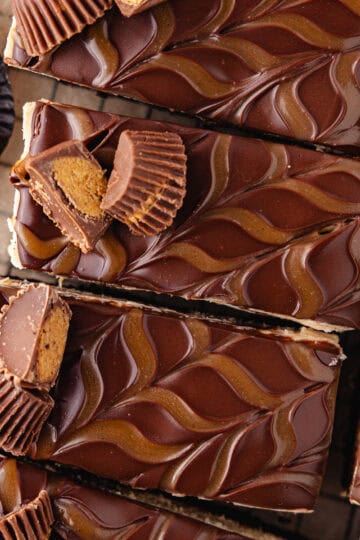 No bake oreo peanut butter cheesecake is topped with chocolate ganache, salted caramel and then cut into bars feature photo.