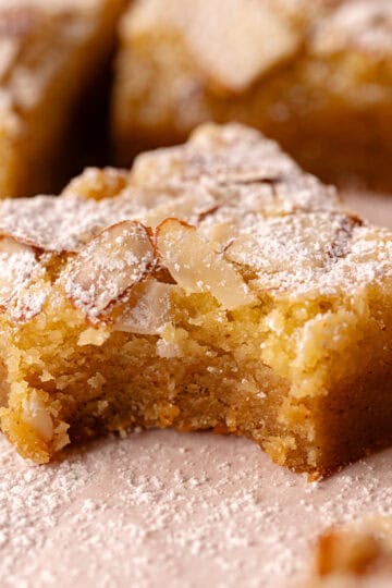 Almond frangipane blondies, also called almond croissant blondies are layered with a brown butter blondie batter, a brown butter almond frangipane and topped with sliced almonds.