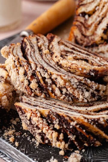 Nutella babka is made by layering tangzhong brioche dough with creamy Nutella and then baked with a cinnamon streusel topping.