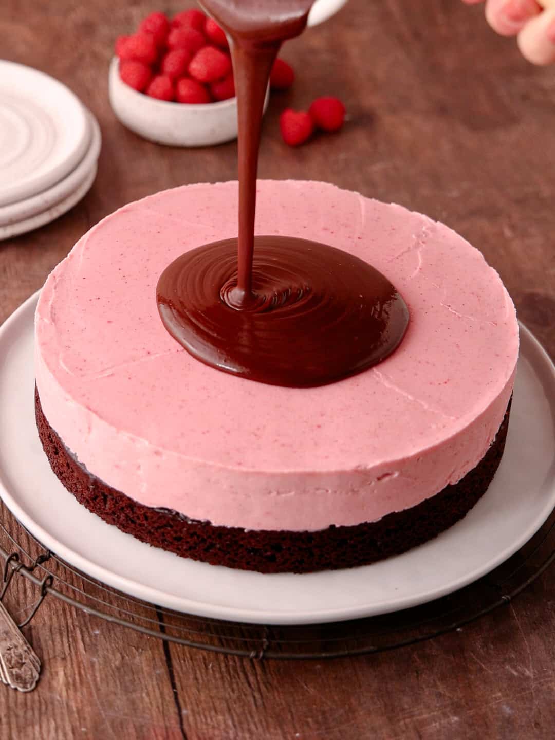 Chocolate ganache is pour on top of the cake.