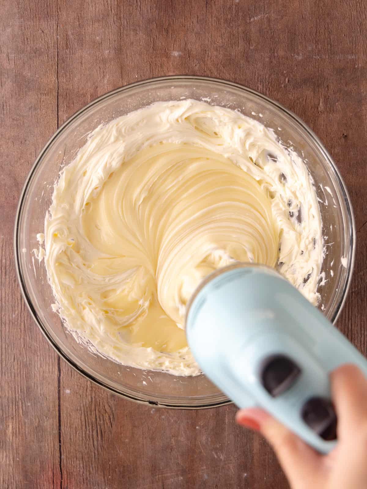 Melted white chocolate cream mixture is whisked into the cream cheese mixture.