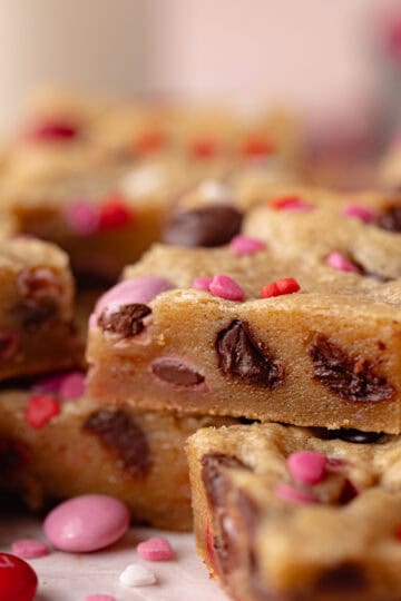 Valentine's Day brown butter blondies loaded with chocolate m&m's, dark chocolate chips, and heart sprinkles.