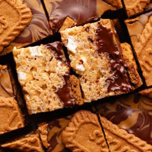 Biscoff rice krispie treats made with marshmallows, cookie butter, rice krispies cereal and topped with chocolate, more cookies butter and Biscoff cookie biscuits.