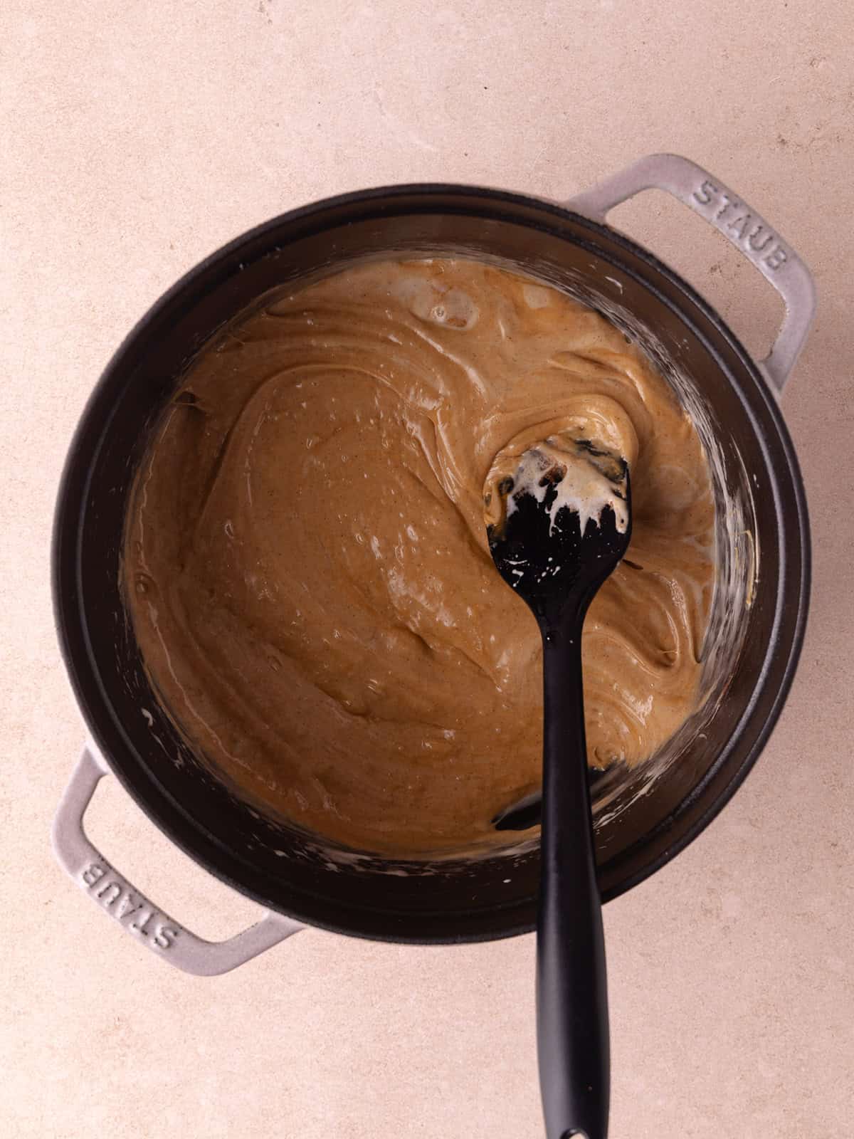 Butter, mini marshmallows, smooth cookie butter, cinnamon, salt and vanilla are added melted together in a dutch oven.