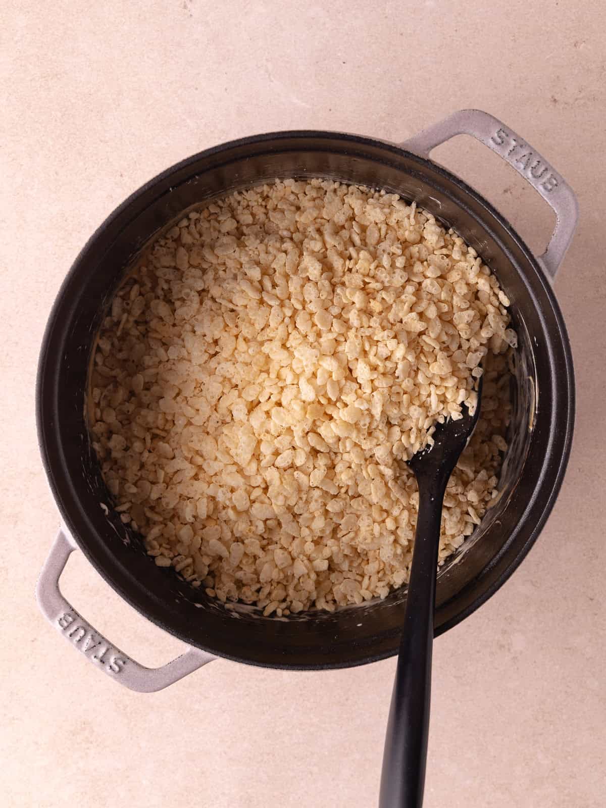 Crispy rice cereal is added to the melted cookie butter marshmallow mixture.