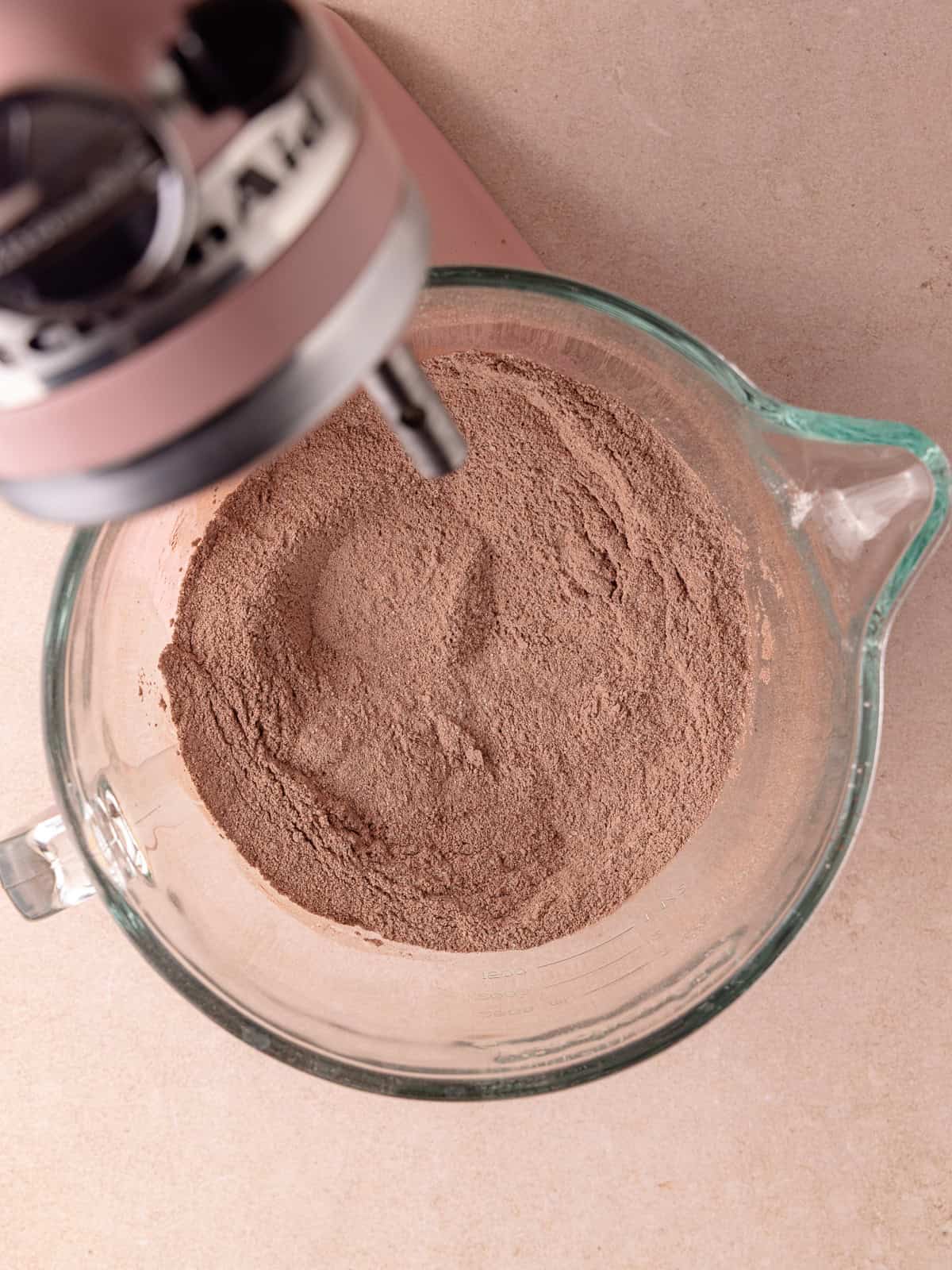 Sugar, sifted flour, cocoa powder, malted milk powder, baking powder, baking soda and salt are whisked together in the bowl of a stand mixer.