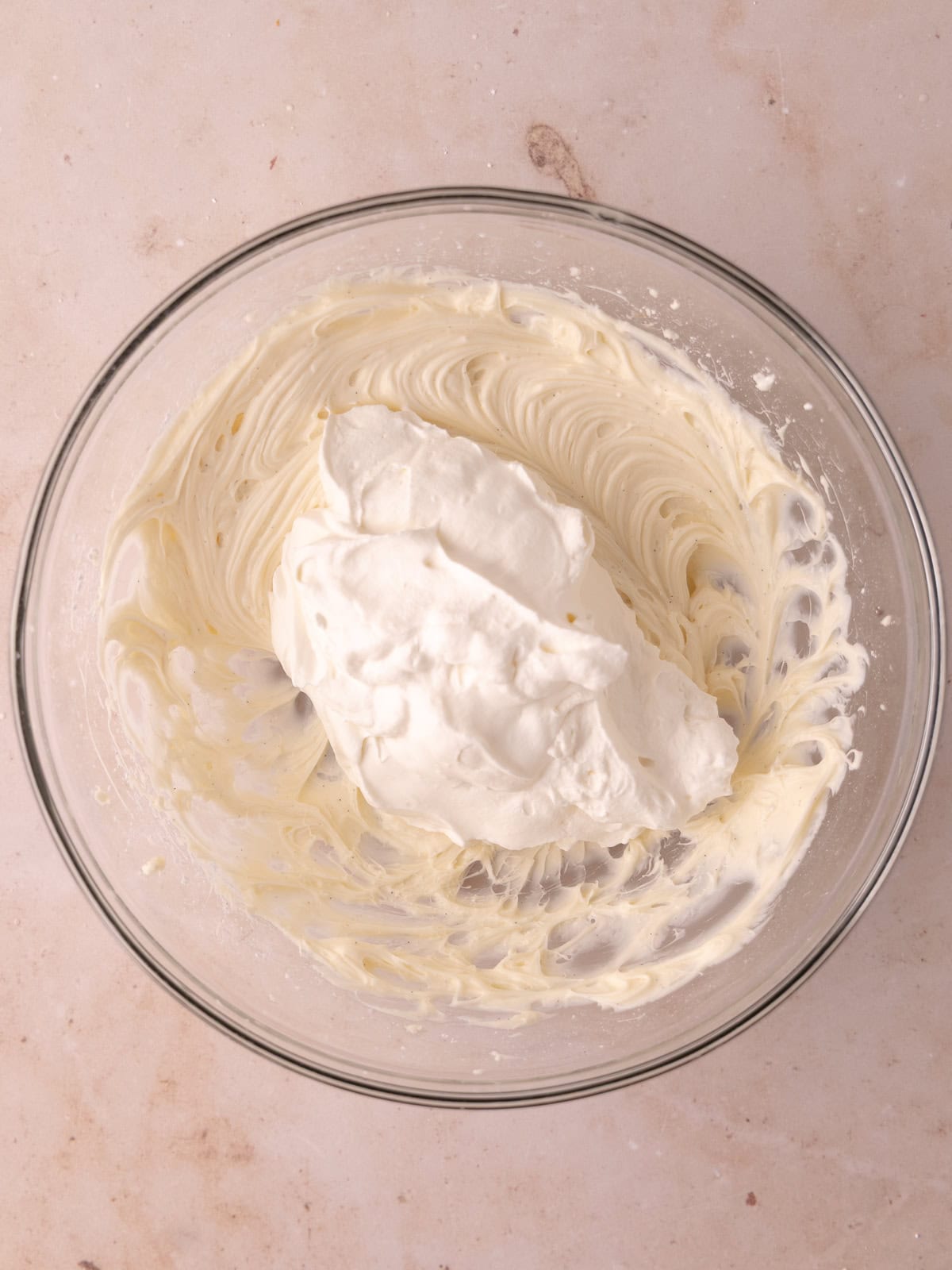 Whipped cream is folded into the cream cheese mixture.