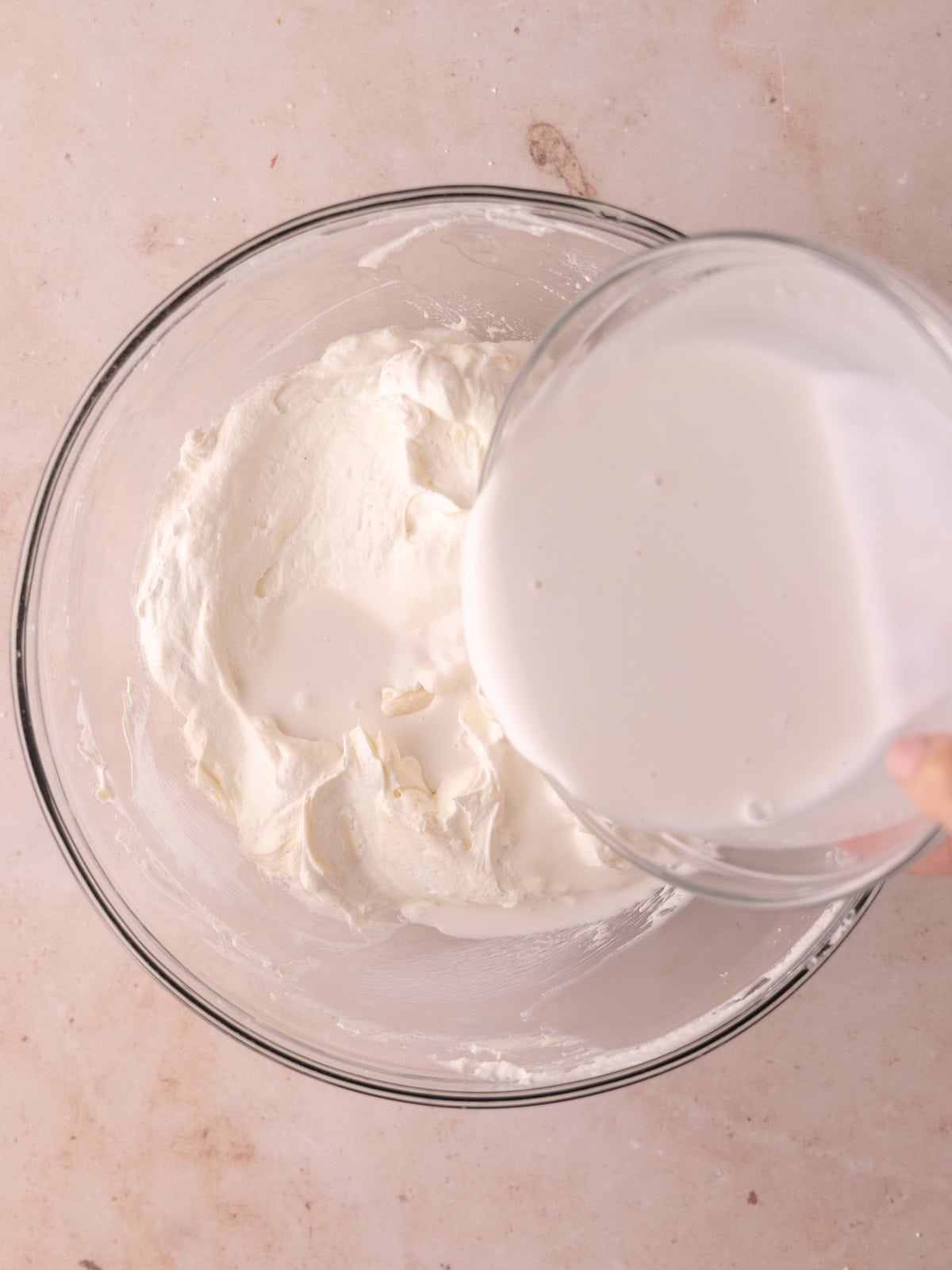Coconut milk gelatin mixture is gradually mixed with the cream cheese whipped cream mixture.