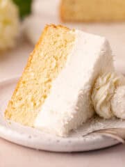Dreamy coconut mousse cake featuring a super moist coconut cake base, layered with a light and creamy coconut mousse, shredded coconut and Raffaello candy!