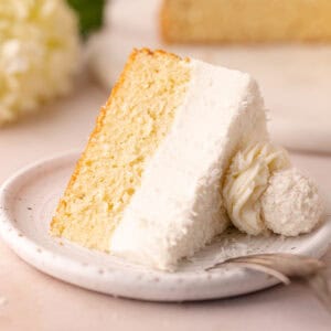 Dreamy coconut mousse cake featuring a super moist coconut cake base, layered with a light and creamy coconut mousse, shredded coconut and Raffaello candy!