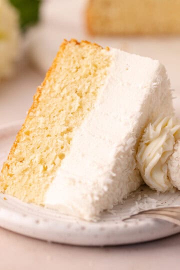 Dreamy coconut mousse cake featuring a super moist coconut cake base, layered with a light and creamy coconut mousse, shredded coconut and Raffaello candy!