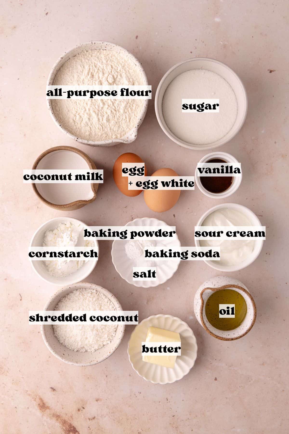 Coconut Mousse Cake ingredients which include, flour, cornstarch, baking powder, baking soda, salt, sugar, shredded coconut, oil, butter, sour cream, whole egg, egg white, vanilla and coconut milk.