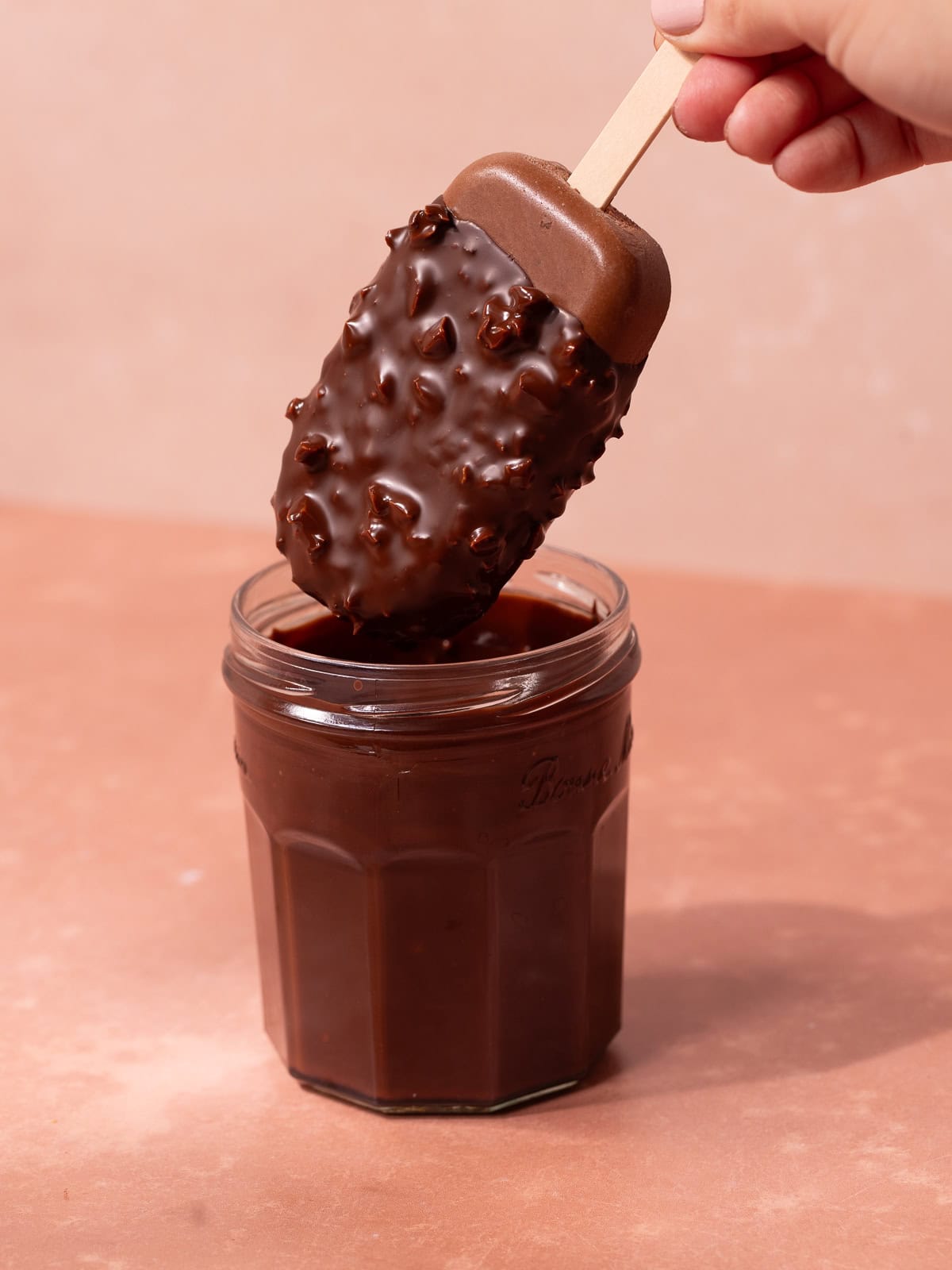 Magnum style super creamy chocolate coconut popsicles are dipped in a hazelnut chocolate magic shell.