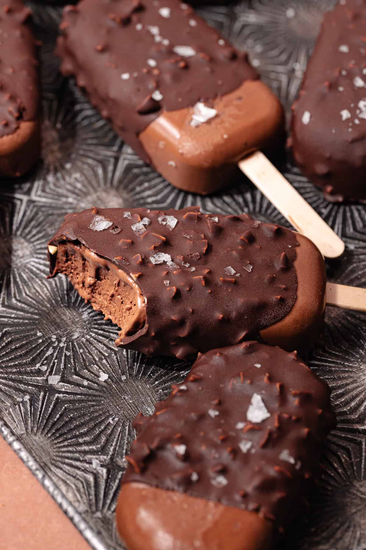 Magnum style super creamy chocolate coconut popsicles are dipped in a hazelnut chocolate magic shell.