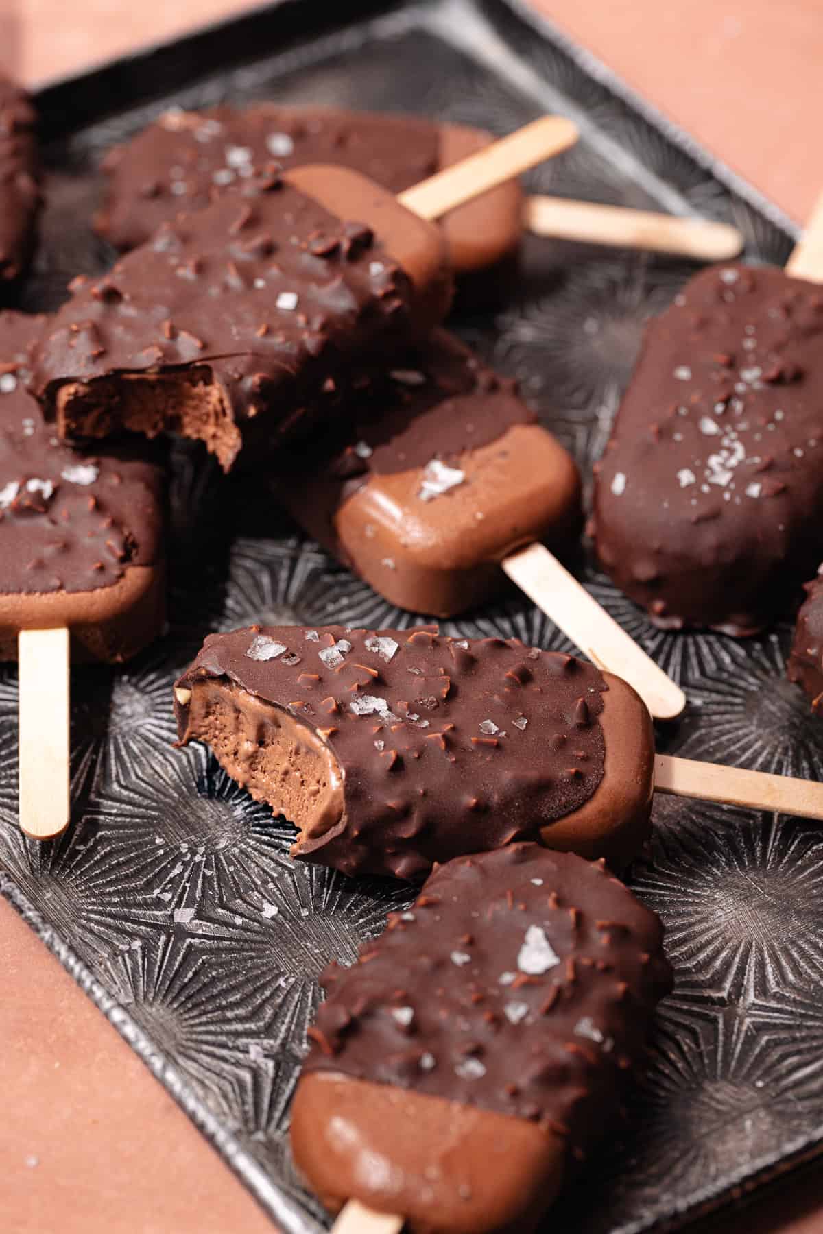 Magnum style super creamy chocolate coconut popsicles are dipped in a hazelnut chocolate magic shell.
