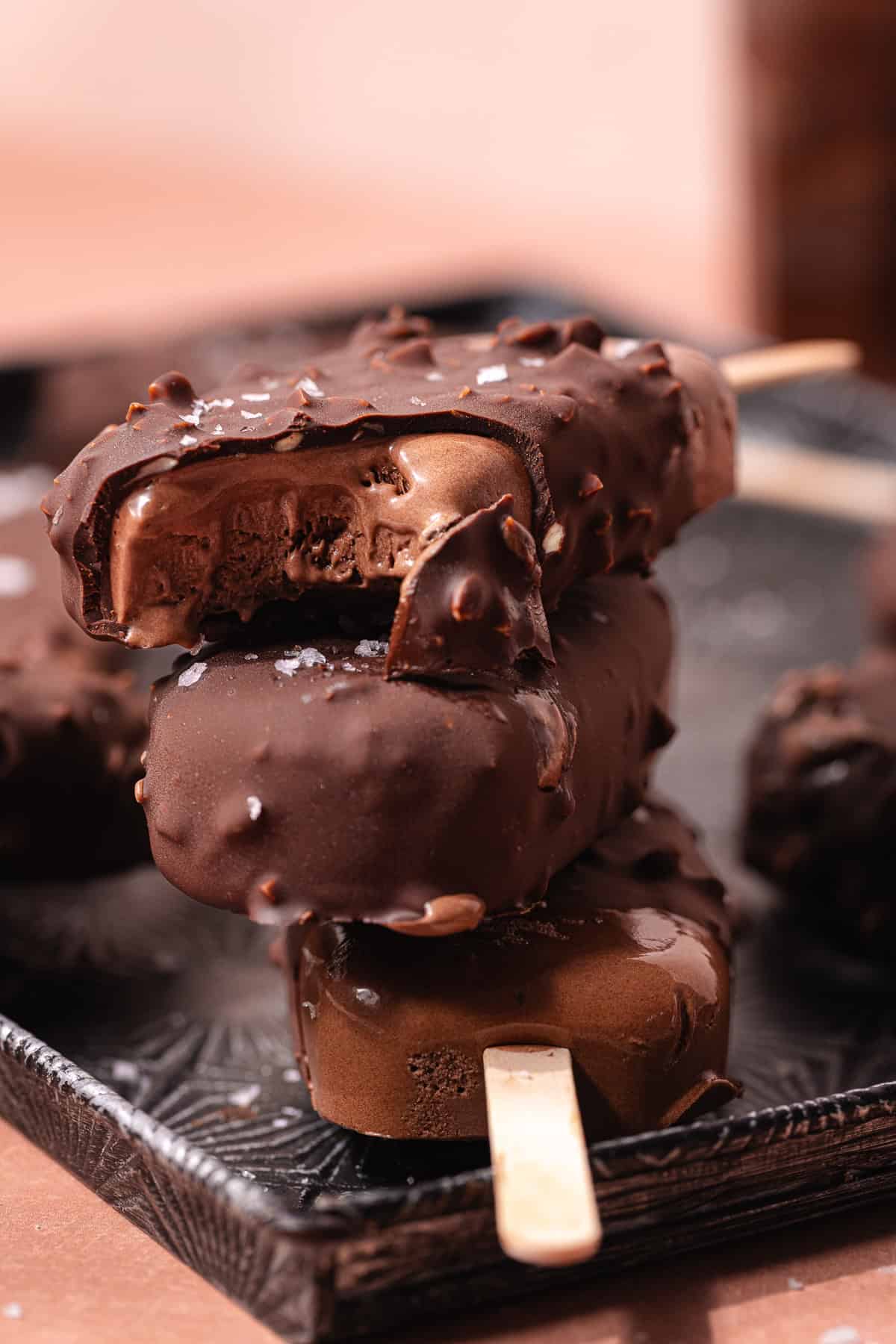 Magnum style super creamy chocolate coconut popsicles are dipped in a hazelnut chocolate magic shell.
