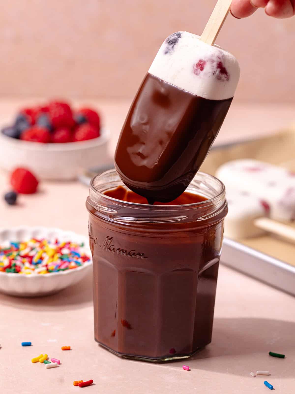 Cream berry coconut popsicles are dipped in a magic chocolate shell.