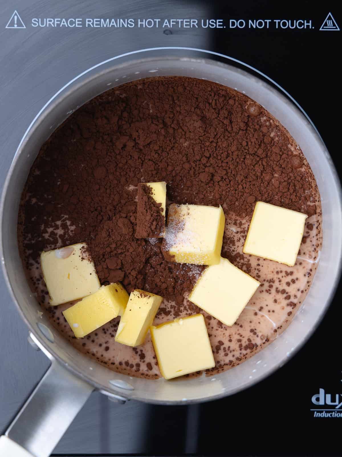 Whole milk, cocoa powder, cubed unsalted butter, and salt are in a small saucepan.