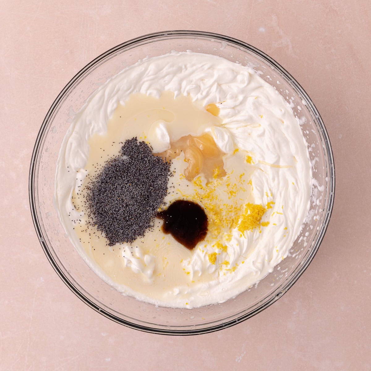 Sweetened condensed milk, lemon curd, fine lemon zest, lemon juice, vanilla and poppy seeds are added to the bowl of whipped cream.
