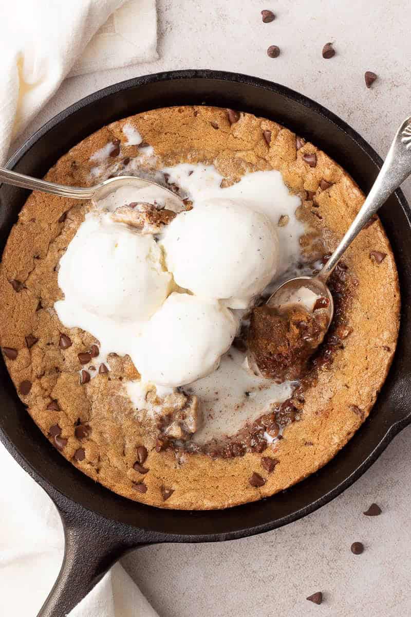 Mini skillet chocolate chip cookie topped with vanilla ice cream.