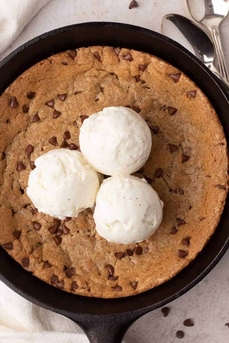 Mini skillet chocolate chip cookie topped with vanilla ice cream.