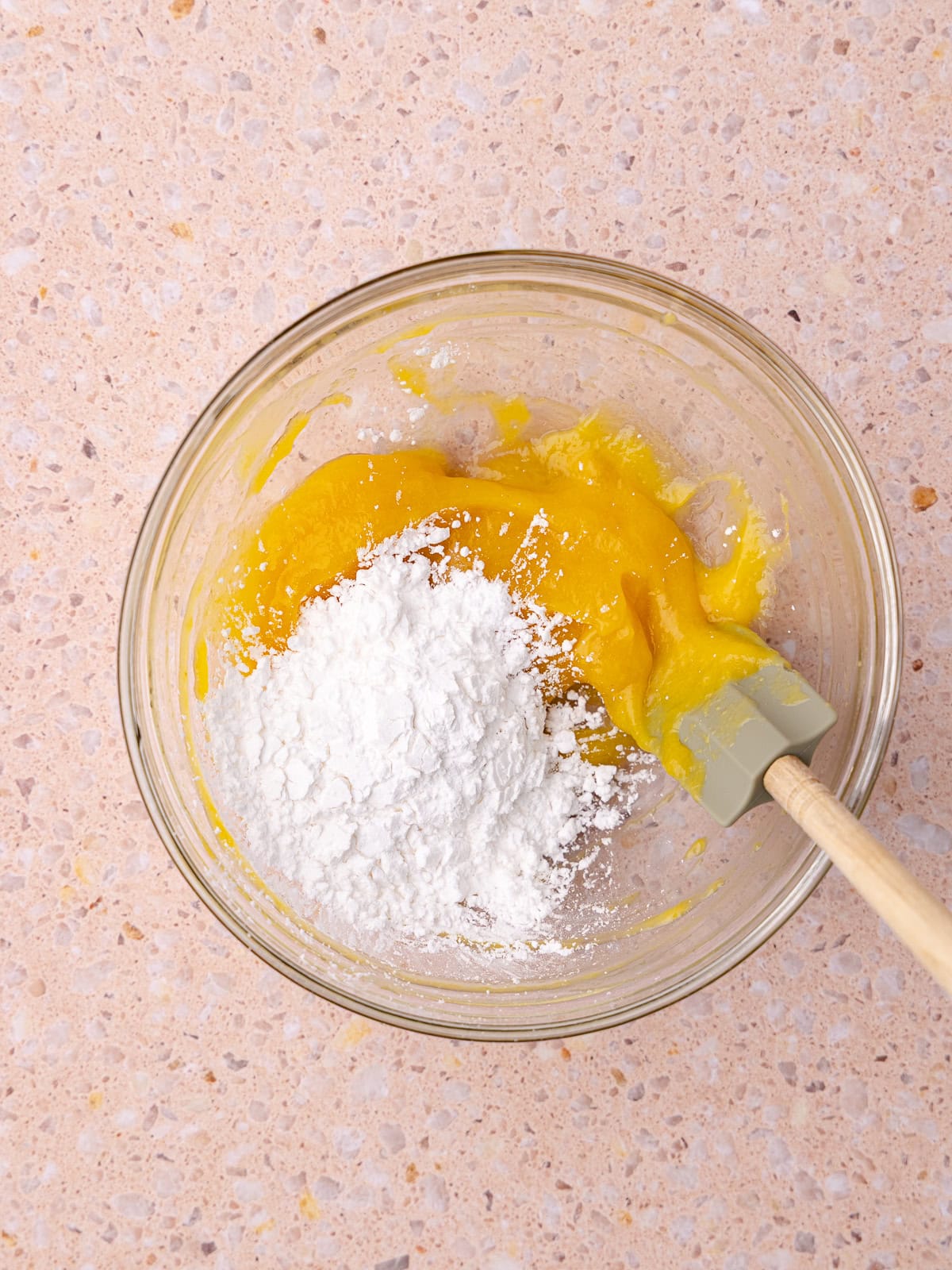 More tapioca flour is added to the bowl with the thickened peach tapioca mixture.