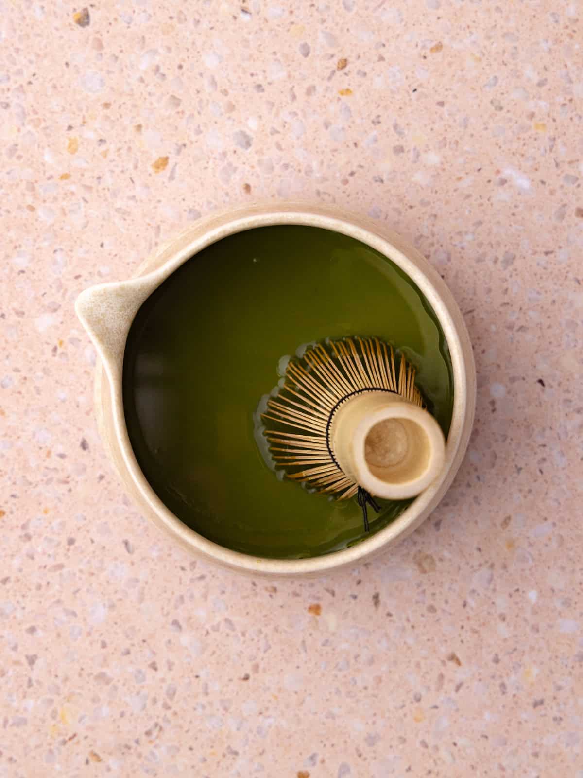 Sifted match powder and hot water are whisked together until combined.