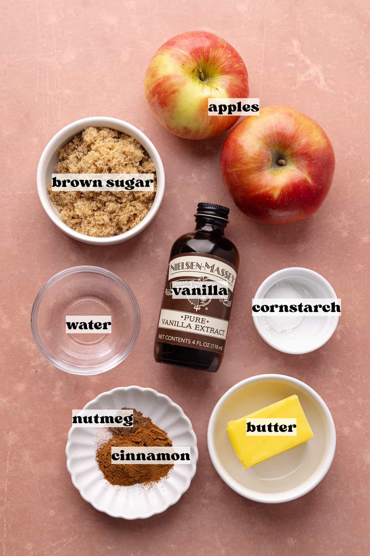 Apple pie filling ingredients which include apples, brown sugar, butter, cinnamon, nutmeg, cornstarch and vanilla.