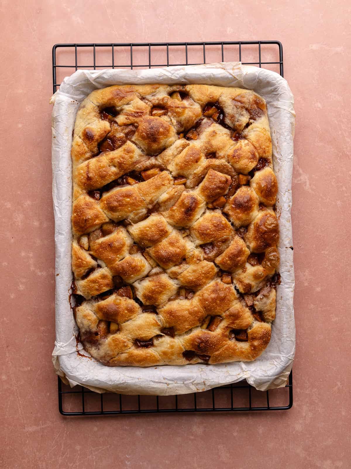 Apple fritter focaccia dough is baked until golden brown.