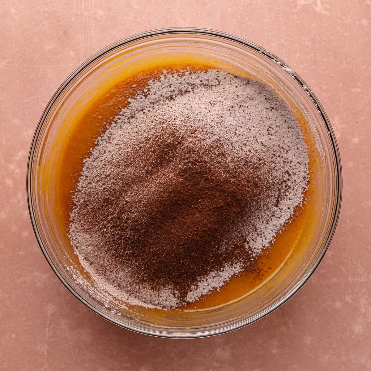 Dry ingredients are sifted into the wet ingredients.